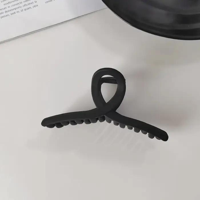 Pince à cheveux élégante noire géométrique en plastique pour femme