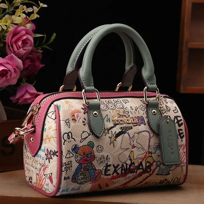Sac Boston de luxe et vintage à porter à la main avec motifs graffiti de dessins animés tendance et cuir premium